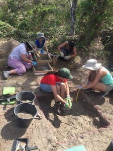 Gabriela, Gelenia and Alexis shifting a looking through our artifacts (above, left to right), while Kaylee and Gabby (below, left to right) measure their unit elevations. (Photo by Taylor Bowden 2018)